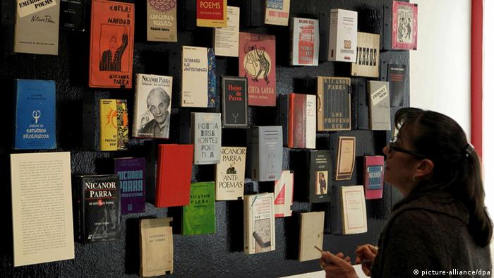 epa03484372 A woman looks at a book display of Chilean poet Nicanor Parra during the opening of the exhibition 'Public Works: Artefacts of Nicanor Parra' at the Cabanas Arts Center in Guadalajara, Mexico, 23 November 2012. The exhibition is held as part of the 26th Guadalajara International Book Fair, which opens on 24 November. EPA/ULISES RUIZ BASURTO