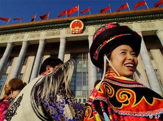 Chinese ethnic minority delegates arrive to attend the opening session of the 10th National People's Congress (NPC) at the Great Hall of the People in Beijing, China, Friday, March 5, 2004. China's government is promising heavy new spending in 2004 to improve the lives of millions of farm families, financed by robust but slower economic growth of 7 percent and aggressive new capitalist-style reforms. (AP Photo/Eugene Hoshiko)