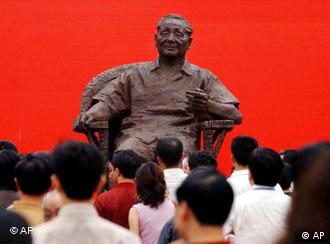 Visitors look at the bronze statue of Deng Xiaoping which was installed to celebrate the 100th anniversary of his birth, on Saturday, Aug. 21, 2004 in Guangan, Deng's hometown, southwest China. Deng, former leader of China from 1978 to 1989, was born Aug. 22, 1904, in Sichuan Province, China, and several official events will be carried out for the anniversary nationwide. (AP Photo/Eugene Hoshiko)