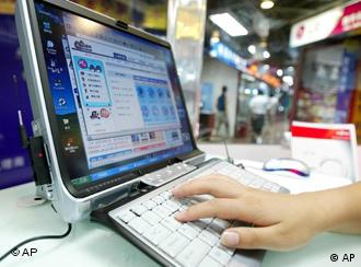 A woman uses the internet at a computer store in Beijing in this July 21, 2004 file photo. Students in Beijing held protests after Chinese authorities barred non-students from using Shuimu.com, a Tsinghua University chat room which had become China's biggest university forum, on March 16, 2005. For 10 years, students, alumni and others used it for lively debates on everything from physics to politics. Now, due to the communist government's crackdown on subversive comments, the site is closed to users outside the university campus.  (AP Photo/Greg Baker, File)
