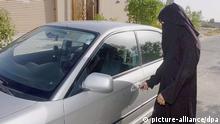 A Saudi woman opening her car