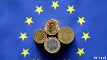Euro coins on top of an EU flag