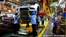 Chinese factory workers assemble Ford cars on the production line