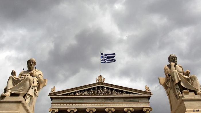 The marble statues of ancient Greek philosophers Socrates, right, and Plato left stand in front of the Athens Academy, as the Greek flag flies on Tuesday, April 19, 2011. Greece had to pay a higher rate to raise euro1.65 billion ($2.36 billion) on Tuesday as market pressures increased amid fears the government will have to default on its massive debt load. (AP Photo/ Petros Giannakouris)