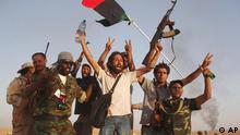 Rebel fighters celebrate as smoke rises from Bani Walid, Libya
(Photo:Alexandre Meneghini, File/AP/dapd).