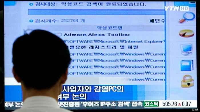 An unidentified police officer of the Cyber Terror Response Center under the National Police Agency, watches a television news broadcasting about cyber attack at the agency's headquarters in Seoul, South Korea, Thursday, July 9, 2009. North Korea, which has been firing missiles and spewing threats against the United States, has been identified by South Korea's main spy agency as a suspect in the cyber attacks targeting government and other Web sites in the U.S. and South Korea.(AP Photo/Ahn Young-joon)<br />