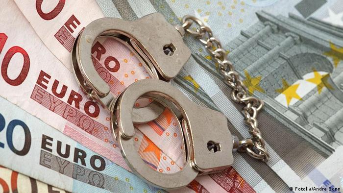 Handcuffs on euro banknotes