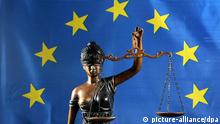 Statue of blindfolded Justitia holding balanced scales with the EU's flag in the background
Photo: Peter Endig +++(c) dpa - Report+++
