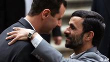 Iranian President Mahmoud Ahmadinejad, right, welcomes his Syrian counterpart Bashar Assad during an official welcoming ceremony for Assad, in Tehran, Iran