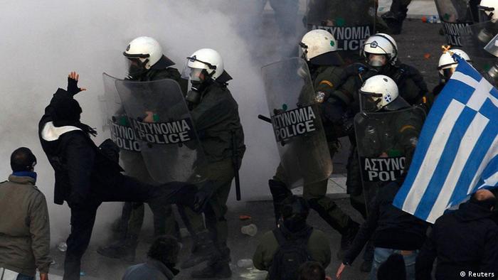 Demonstrators clash with riot police during a huge anti-austerity demonstration in Athens' Syntagma (Constitution) square February 12, 2012