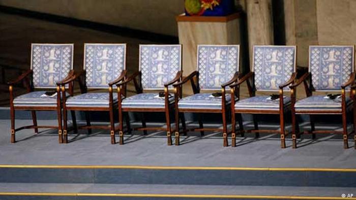 An empty chair, second from left with no headests or program, is seen before a ceremony honoring Nobel Peace Prize laureate Liu Xiaobo at city hall in Oslo, Norway Friday Dec. 10, 2010. Liu, a democracy activist, is serving an 11-year prison sentence in China on subversion charges brought after he co-authored a bold call for sweeping changes to Beijing's one-party communist political system. (AP Photo/John McConnico)