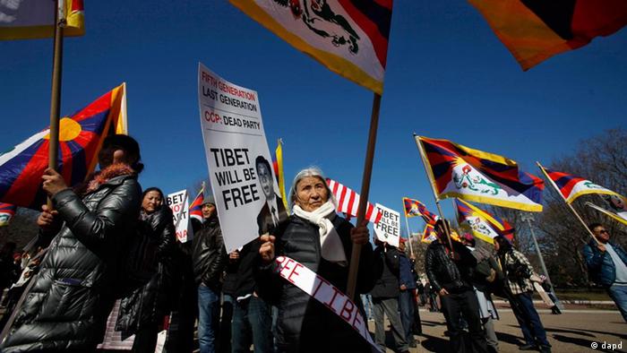 Lhakpa Dolma, 74, center, and other Tibetans and supporters, take part in a demonstration outside the White House in Washington, Monday, Feb. 13, 2012, to draw attention to Tibet before an expected visit to the White House from China's Vice President Xi Jinping. (AP Photo/Jacquelyn Martin)