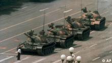 A Chinese man stands alone to block a line of tanks heading east on Beijing's Cangan Blvd. in Tiananmen Square on June 5, 1989. The man, calling for an end to the recent violence and bloodshed against pro-democracy demonstrators, was pulled away by bystanders, and the tanks continued on their way. The Chinese government crushed a student-led demonstration for democratic reform and against government corruption, killing hundreds, or perhaps thousands of demonstrators in the strongest anti-government protest since the 1949 revolution. Ironically, the name Tiananmen means "Gate of Heavenly Peace". (AP Photo/Jeff Widener) 