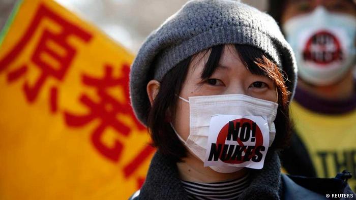 Anti-nuclear protesters attend a rally in Tokyo February 19, 2012. The characters in the background read 