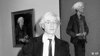 In this June 3, 1976 file photo, Pop artist Andy Warhol poses in front of a portrait of himself at the show Andy Warhol and Jamie Wyeth: Portraits of Each Other at the Coe Kerr Gallery in New York. Warhol's movies and video share the stage with his more familiar Campbell's soup-can paintings and colorful celebrity prints in Andy Warhol: Other Voices, Other Rooms, an exhibition running through Feb. 15 at the Wexner, at Ohio State University. (ddp images/AP Photo)
