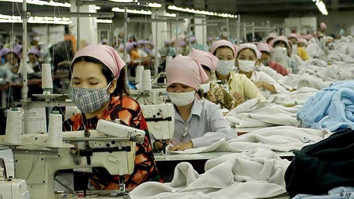 Cambodian garment factory workers toil at the W&D garment factory, just southeast of Phnom Penh, April 28, 2004. (AP Photo/Isabelle Lesser)