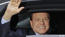 Then-Italian Premier Silvio Berlusconi waving from his car 