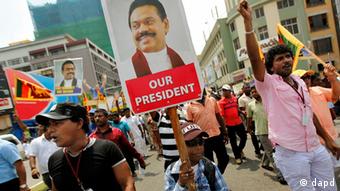 A Sri Lankan boy displays a cutout of President Mahinda Rajapaksa during a street march, in Colombo, Sri Lanka, Monday, Feb. 27, 2012
(Photo:Gemunu Amarasinghe/AP/dapd)