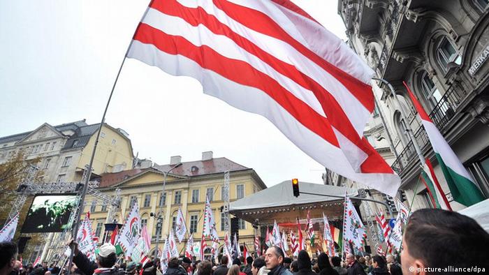Supporters of Jobbik wave a huge historical red-and-white flag during a demonstration
EPA/ZOLTAN MATHE 