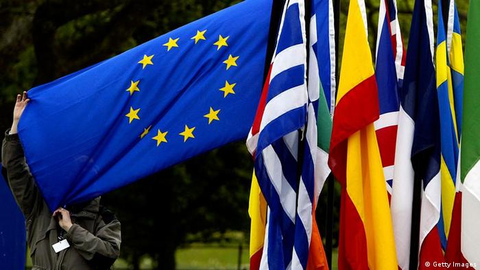 A man checks the flags of the European Union countries as they are gathered together ahead of the EU enlargement ceremony in 2004 
Photo: Ian Waldie/Getty Images