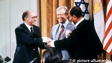 Anwar el Sadat and Menachem Begin shake hands in 1979