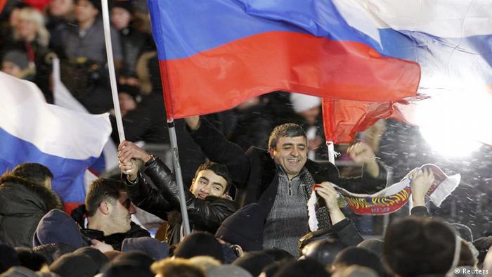 People take part in a rally in support of Vladimir Putin