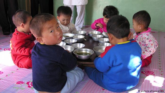 A handout picture released 31 October 2005 shows children eating their lunch at a government run nursery in Pyongyang on 18 October 2005. About 57 per cent of North Koreans do not get enough to eat to keep them healthy, the WFP announced. EPA/HO +++(c) dpa - Bildfunk+++ 