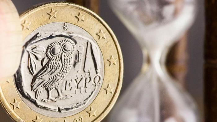 Greek euro coin and  an hour glass