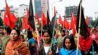 Bangladeshi garments workers carry red and black flag as they protest the killing of their fellow workers in Dhaka, Bangladesh, Tuesday, Nov. 10, 2009. (Photo: AP)