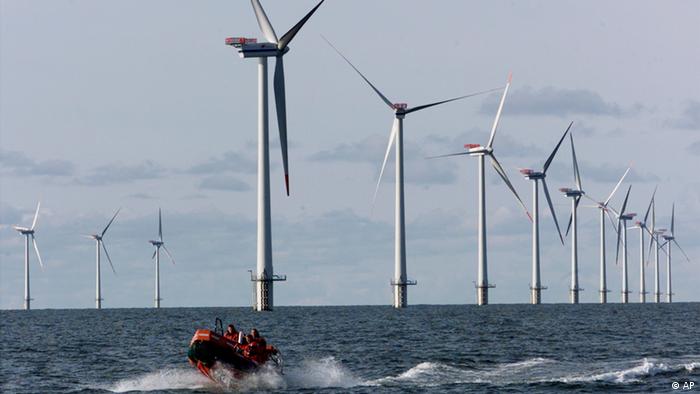 Offshore wind turbines with a small service vessel steering between them