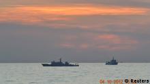 Two Chinese surveillance ships which sailed between a Philippines warship and eight Chinese fishing boats to prevent the arrest of Chinese fishermen in the Scarborough Shoal, a small group of rocky formations whose sovereignty is contested by the Philippines and China, about 124 nautical miles off the Philippine island of Luzon, are seen in the South China Sea in this April 10, 2012 file photo. China withdrew one of three ships engaged in a standoff with Philippines vessels in a disputed area of the South China Sea on April 13, 2012 as both sides pursued talks to defuse the dispute.  REUTERS/Philippine Army Handout/Files (PHILIPPINES - Tags: POLITICS MILITARY MARITIME) FOR EDITORIAL USE ONLY. NOT FOR SALE FOR MARKETING OR ADVERTISING CAMPAIGNS. THIS IMAGE HAS BEEN SUPPLIED BY A THIRD PARTY. IT IS DISTRIBUTED, EXACTLY AS RECEIVED BY REUTERS, AS A SERVICE TO CLIENTS