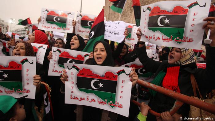 epa03138562 Thousands of Libyans with Libya flags and anti-federalization signs and banners gather during a protest against transforming Libya into a federal state, in Tripoli, Libya, 09 March 2012. Tribal leaders in eastern Libya on 06 March declared the Cyrenaica region to be semi-autonomous, in a move that could revive old tensions in Libya. Thousands of major tribal leaders and militiamen attended the ceremony in the city of Benghazi, the birthplace of last year's uprising against former leader Muammar Gaddafi. EPA/SABRI ELMHEDWI 