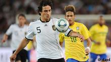 Mats Hummels controls a ball in a friendly against Brazil as Neymar looks on.