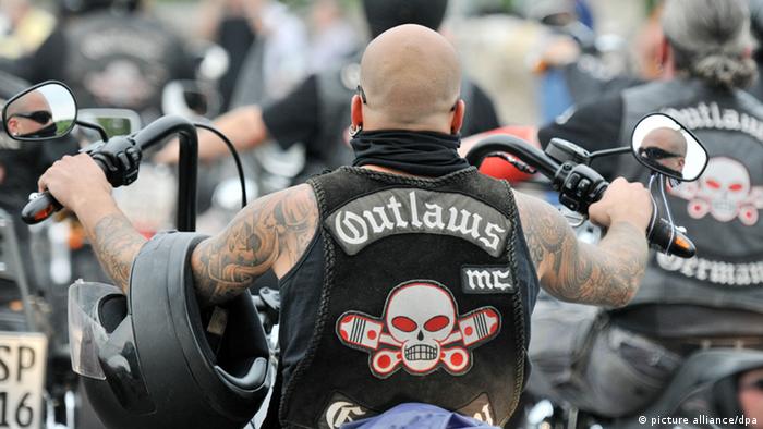 A member of the Outlaw biker gang on his motorcycle