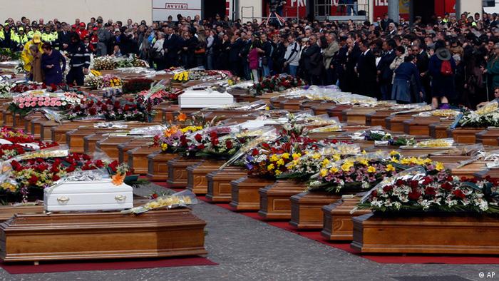 Coffins of victims are lined up during the funerals for quake victims in L'Aquila, central Italy, Friday, April 10, 2009. 