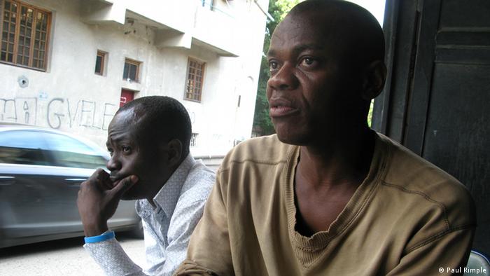 Mirako Arimze (left) and Sylvester Chinyelugo sitting near the carwash in Tblissi
