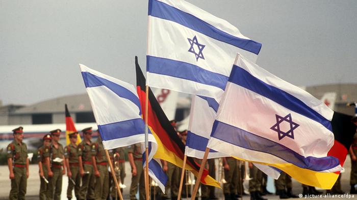 German and Israeli flags being waved in the air