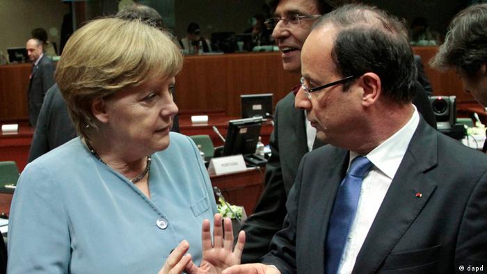 French President Francois Hollande, right, talks with German Chancellor Angela Merkel, prior to the start of an EU summit, at the European Council building in Brussels, Wednesday, May 23, 2012.