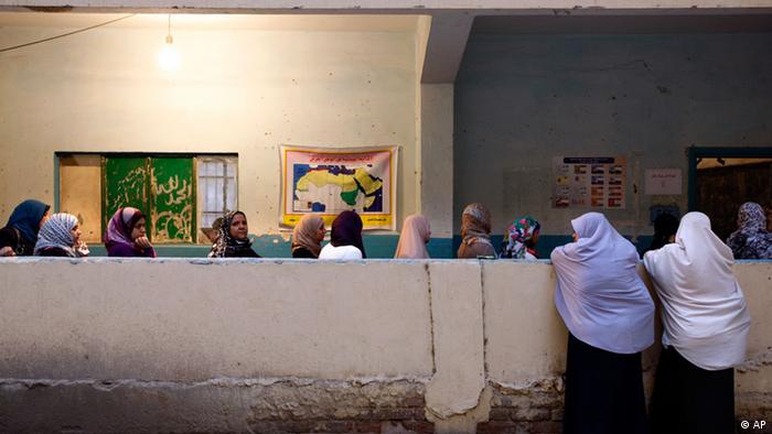 Egyptian women wait in line to vote in the presidential election 