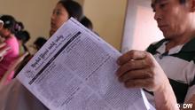 Burmese refugee reads the newspaper