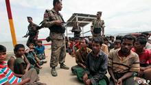 Rohingya Muslim men, fleeing from ethnic violence in Myanmar are intercepted by Bangladeshi guards