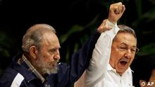 FOR USE AS DESIRED, YEAR END PHOTOS - FILE -In this April 19, 2011 file photo, Fidel Castro, left, raises his brother's hand, Cuba's President Raul Castro, center, as they sing the anthem of international socialism during the 6th Communist Party Congress in Havana, Cuba. Raul Castro was named first secretary of Cuba's Communist Party, with his brother Fidel not included in the leadership for the first time since the party's creation 46 years ago. (AP Photo/Javier Galeano, File)
