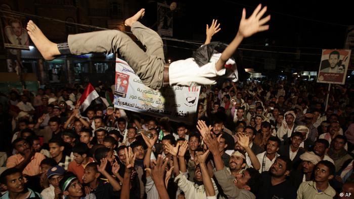 Yemeni protestors celebrate the victory of the newly elected President Mohammed Morsi during a rally at Taghyeer (Change) Square in Sanaa. Yemen, Sunday, June 24, 2012. Morsi has called for unity and said he carries 