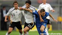 Michael Ballack (C) from Germany vies with Francesco Totti (R) from Italy during the semi final of the 2006 FIFA World Cup between Germany and Italy in Dortmund, Germany, Tuesday, 04 July 2006.German Sebastian Kehl (L) looks on. 