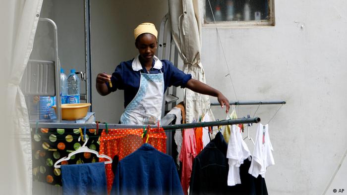 An Ethiopian maid hangs washed clothes as she stands on a balcony in Beirut, Lebanon
Photo: AP Photo/Grace Kassab