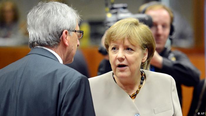 German Chancellor Angela Merkel, left, speaks with Luxembourg's Prime Minister Jean-Claude Juncker