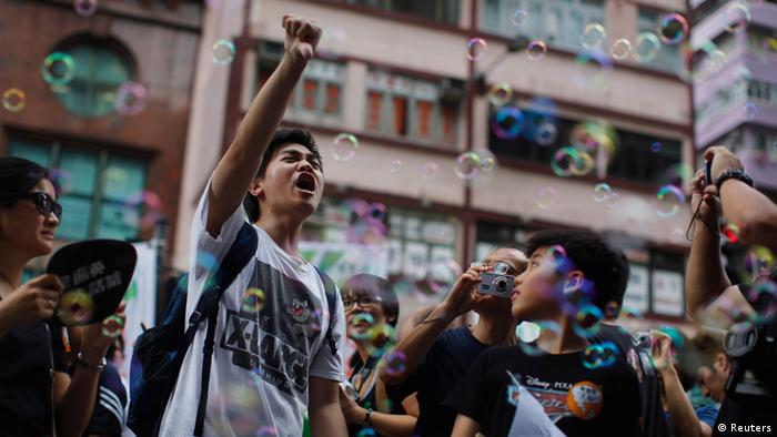 A pro-democracy demonstrator yells slogans as he marches along downtown Hong Kong July 1, 2012, during the 15th anniversary of the territory's handover to China. New Hong Kong leader Leung Chun-ying was sworn into office on Sunday by Chinese President Hu Jintao for a five-year term in which he will confront challenges ranging from human rights to democracy after a tumultuous year of transition and protest. REUTERS/Carlos Barria (CHINA - Tags: POLITICS)