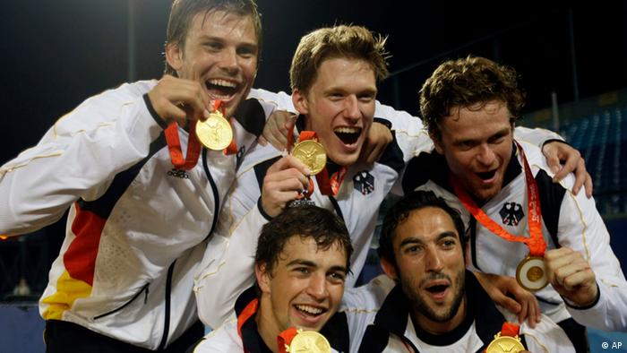 German field hockey players pose with their gold medals at the Beijing 2008 Olympics