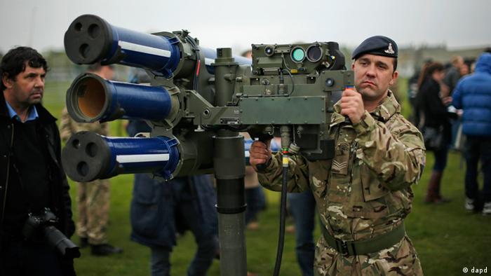 FILE - In this May 3, 2012 file photo, Sergeant Craig from Britain's Royal Artillery regiment holds a high-velocity missile, or HVM, lightweight multiple launcher during a media event ahead of a training exercise designed to test military procedures prior to the Olympic period in Blackheath, London. The British army will be putting HVM missiles, capable of shooting down a hijacked aircraft, on the roof of Fred Wigg Tower, an apartment building on the outskirts of London, as part of its security during the 2012 Olympics. Residents fought the plan, but a High Court judge said Tuesday, July 10, 2012 that the missiles presented 