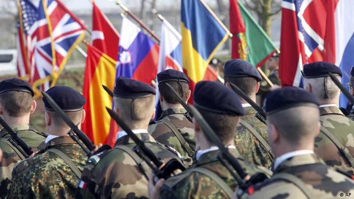 Soldiers participate in a military ceremony at a NATO summit (photo: AP/Christian Lutz)